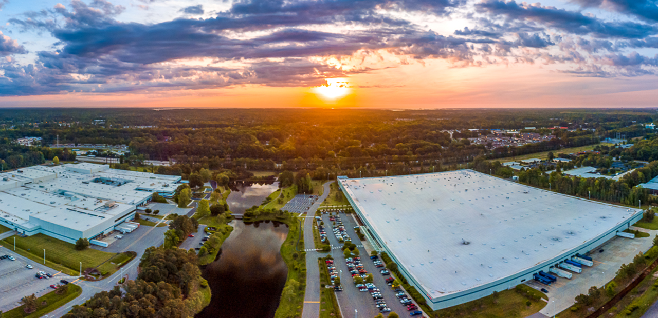 Arial image of the Canon Virginia office building as the sun rises over the horizon