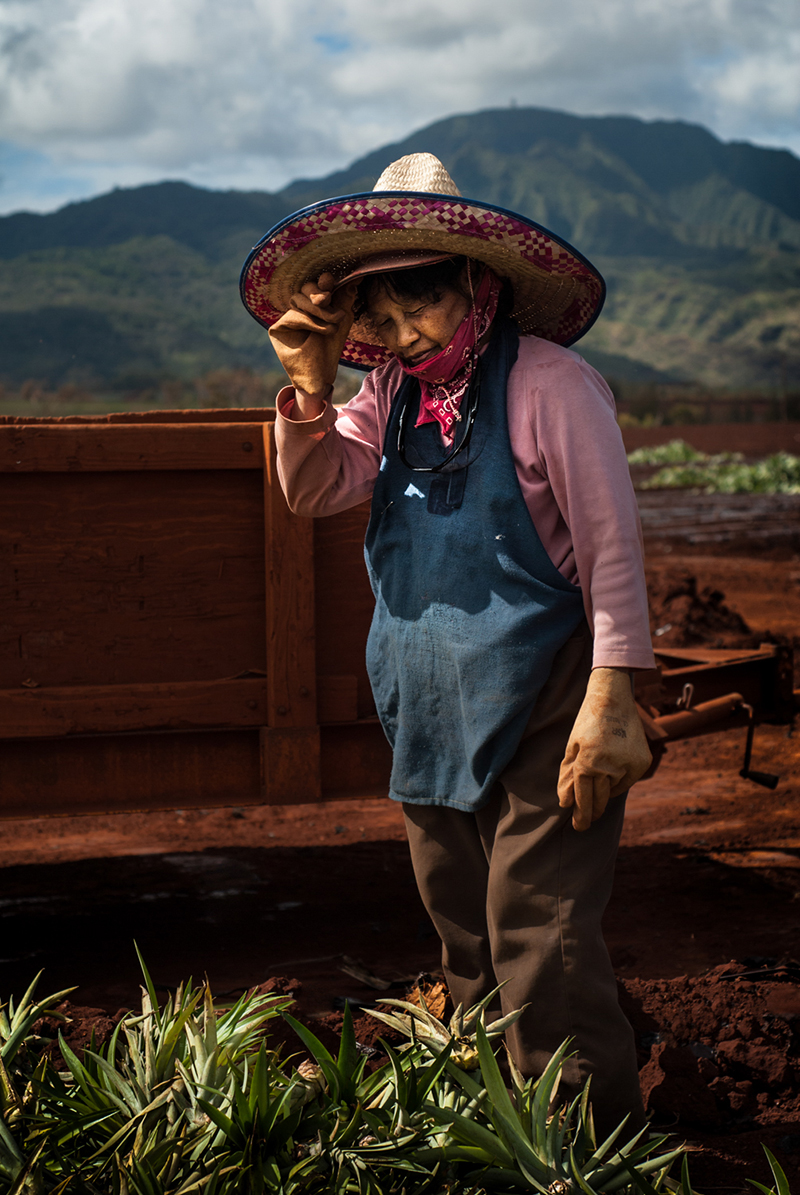portrait photo of a farmer adjusting their hat