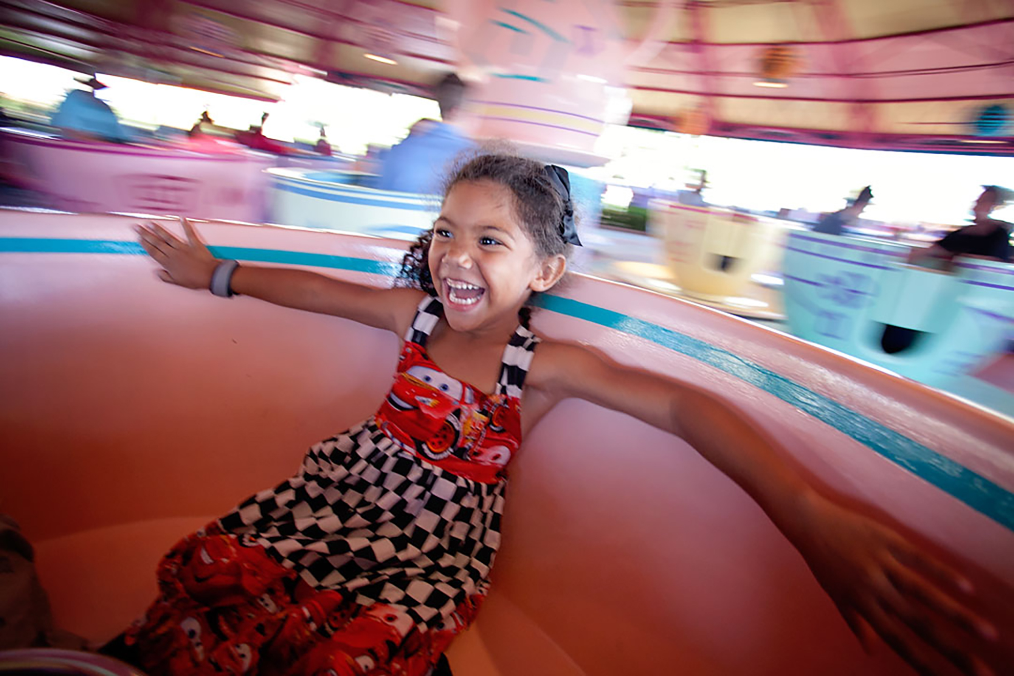 little girl on the Disney teacup ride