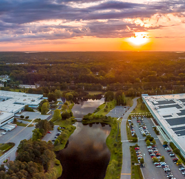 Arial image of the Canon Virginia office building as the sun rises over the horizon