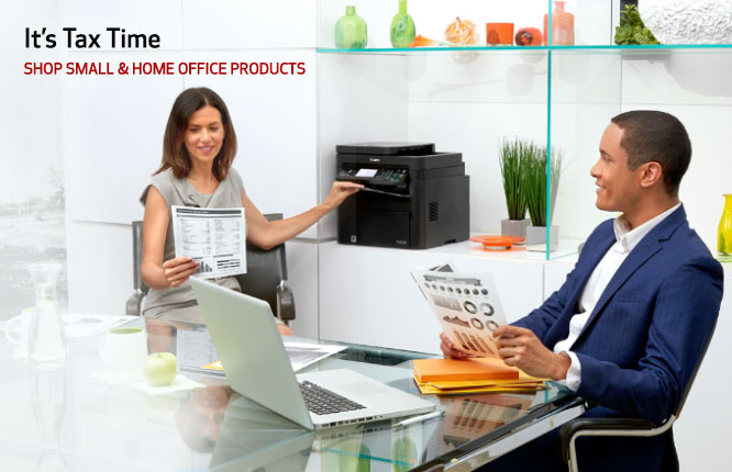 Co-workers discussing a document in an office