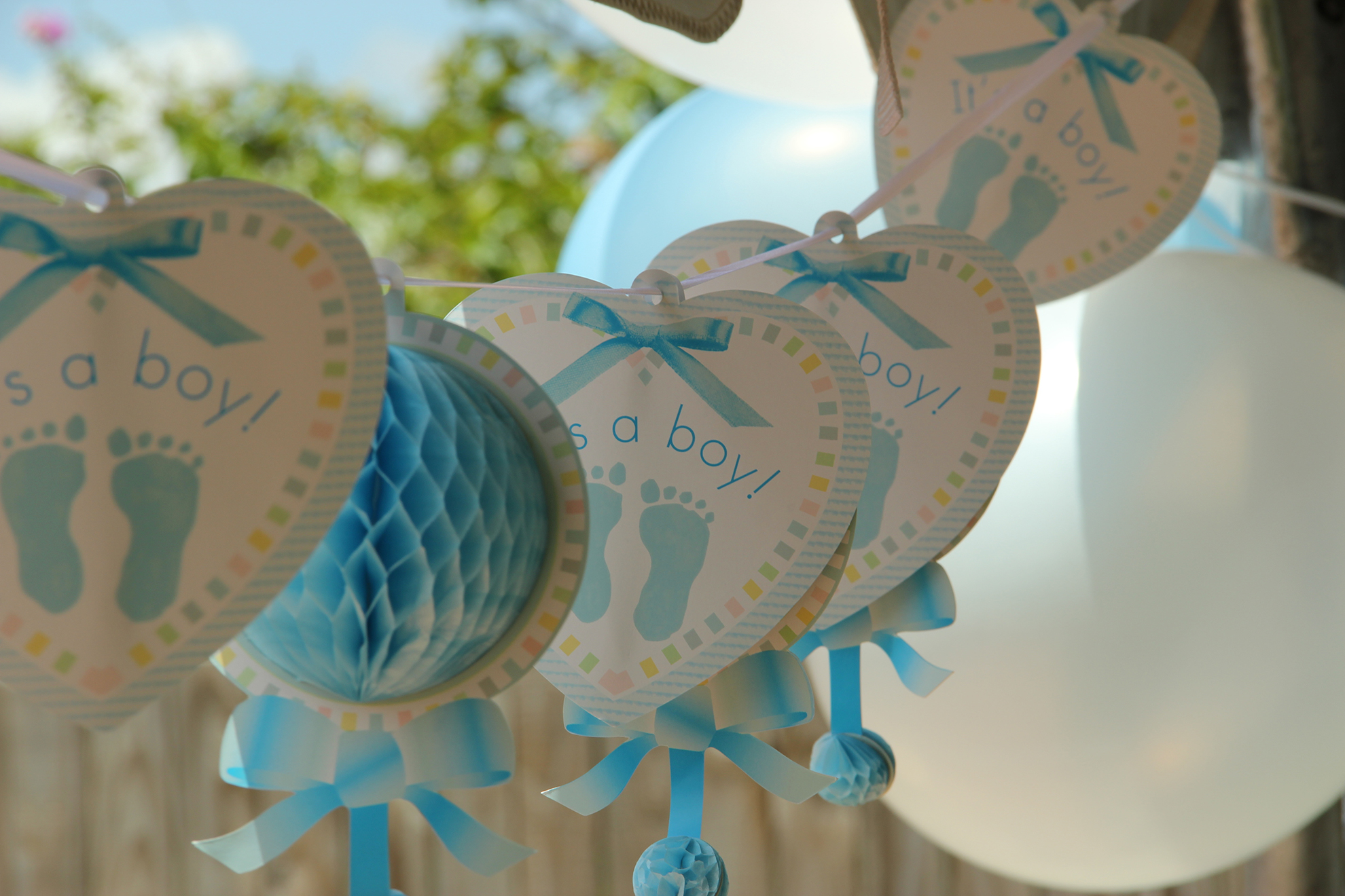 string of it's a boy heart decorations and balloons