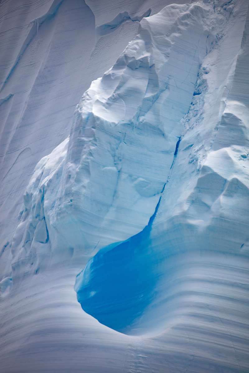 Close up image showcasing the patterns created by the waves in the iceberg