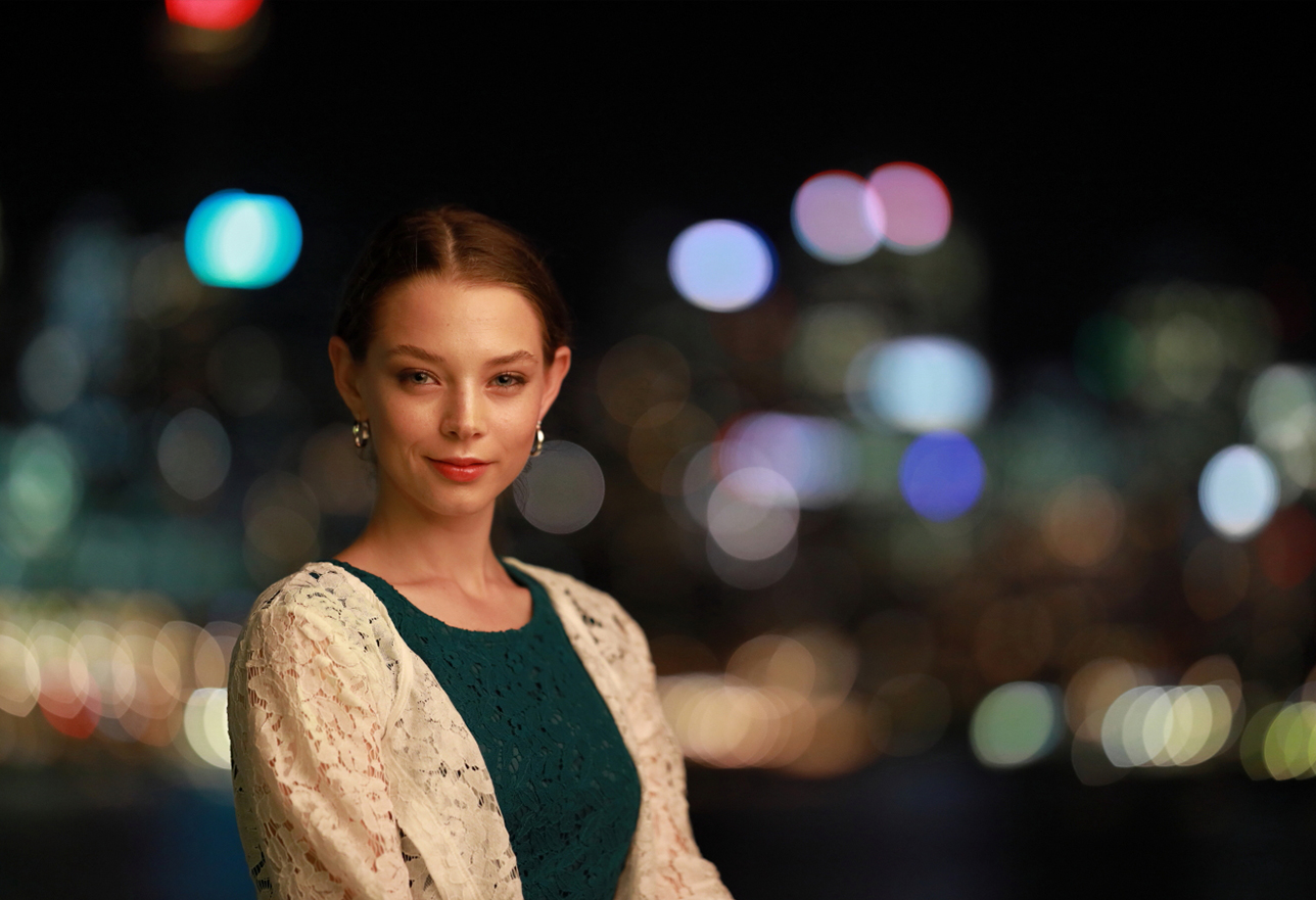portrait of brunette model with a lacey dress and bokeh background
